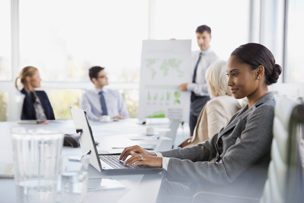 Businesswoman using laptop in meeting