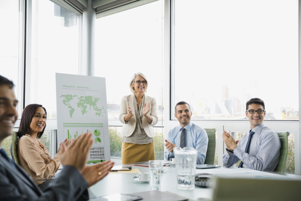 Business people applauding in boardroom